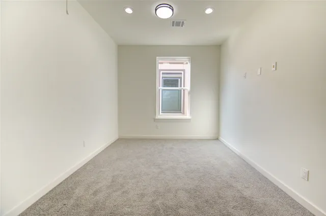 an empty room with windows and closet