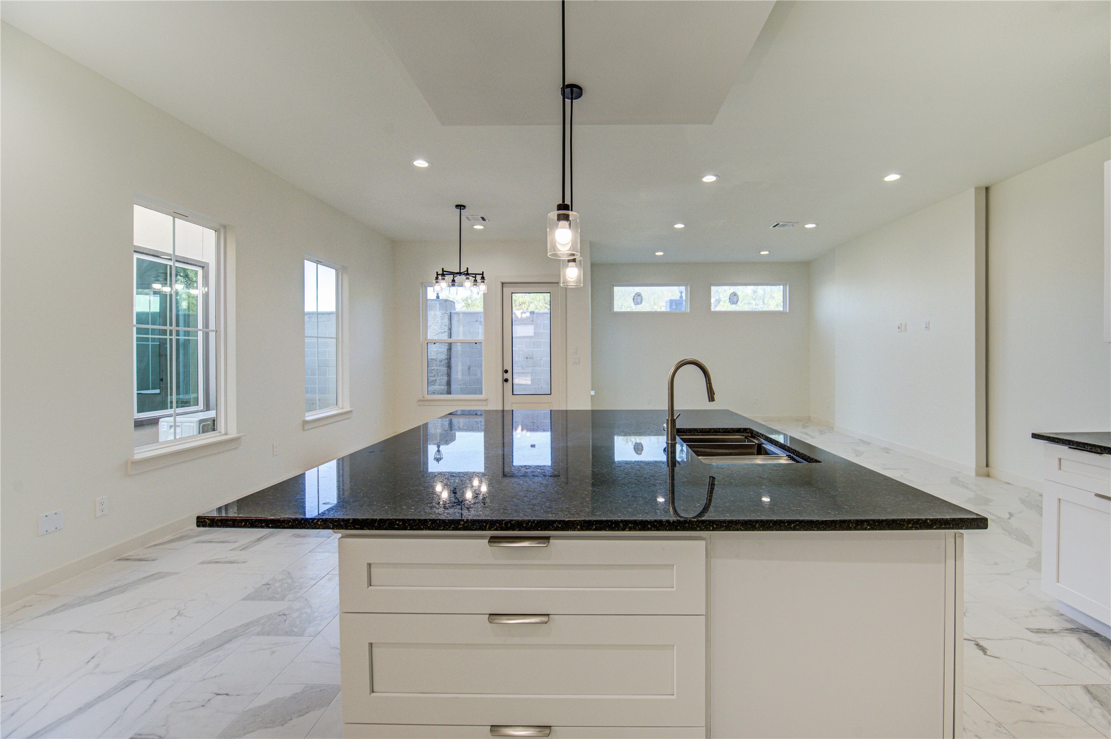 2920 El Fenice Lane Houston, TX 77057 - Photo 39 of 42 a kitchen with kitchen island a sink stainless steel appliances and a counter top space