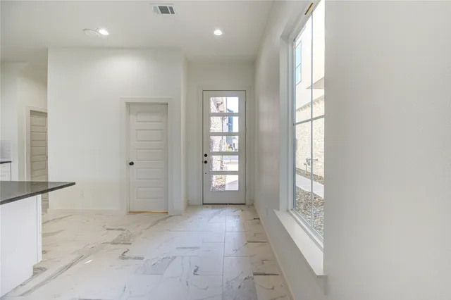 an empty room with windows and closet