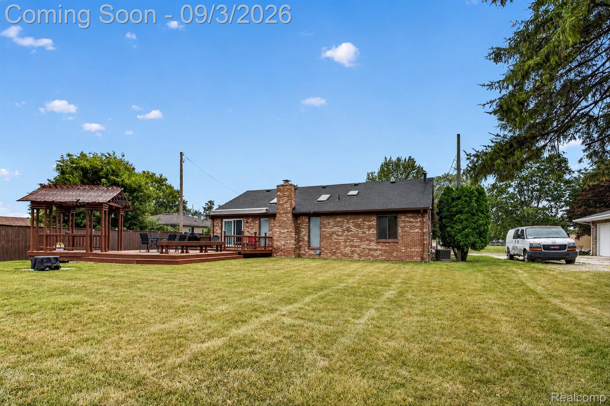 27260 Campbell Road Warren, MI 48093 - Photo 52 of 60 Expansive backyard with a brick exterior, large wooden deck, and a wooden gazebo