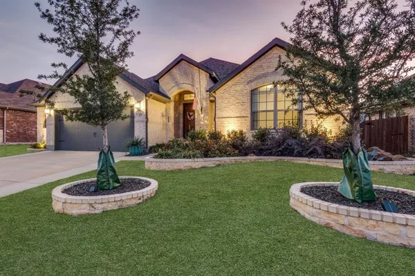 a front view of a house with garden