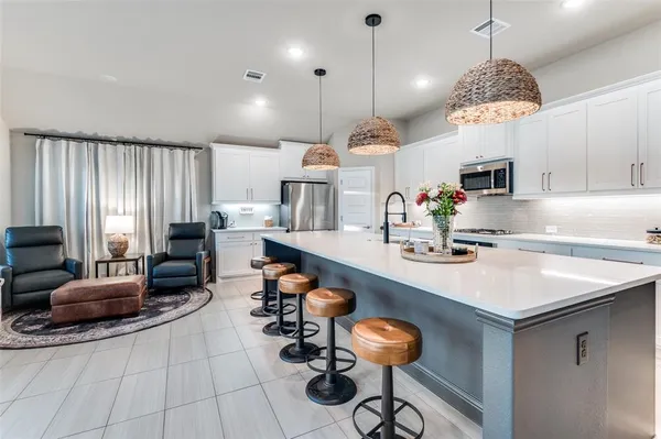 a kitchen with sink cabinets and living room view