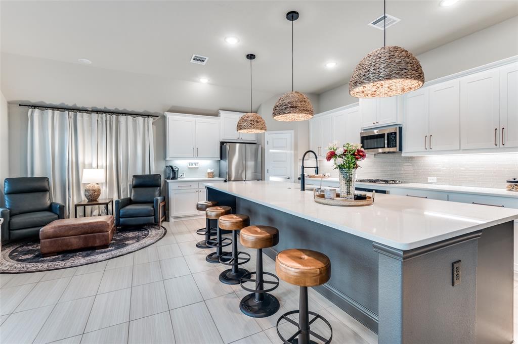 425 Acadia Lane Forney, TX 75126 - Photo 13 of 37 a kitchen with sink cabinets and living room view