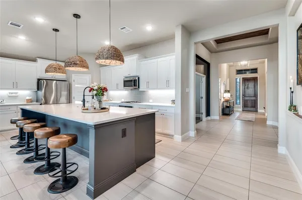 a kitchen with a sink a counter and appliances