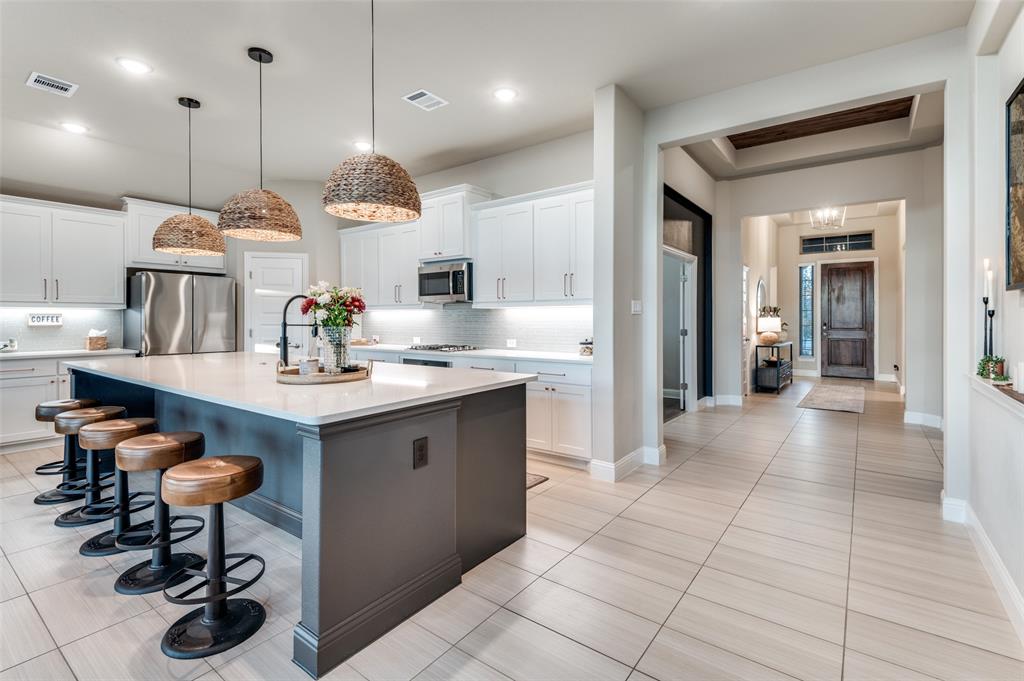 425 Acadia Lane Forney, TX 75126 - Photo 15 of 37 a kitchen with a sink a counter and appliances