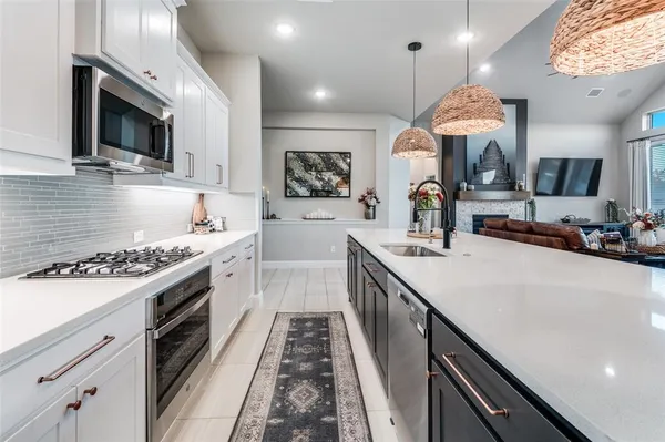a kitchen with a sink stove and microwave