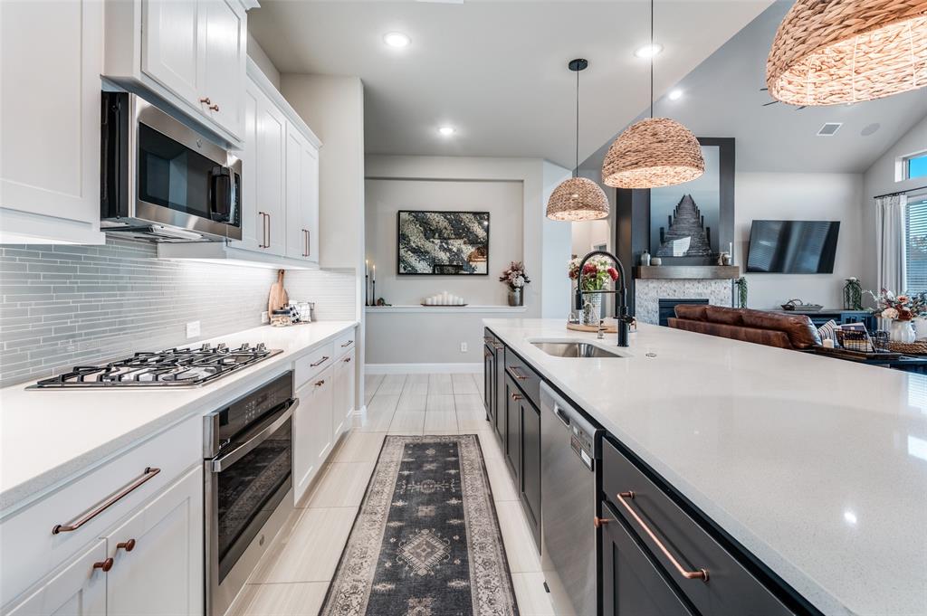 425 Acadia Lane Forney, TX 75126 - Photo 16 of 37 a kitchen with a sink stove and microwave