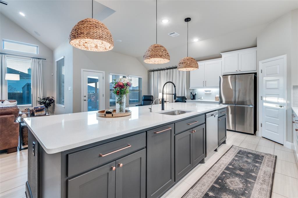 425 Acadia Lane Forney, TX 75126 - Photo 17 of 37 a kitchen with stainless steel appliances a sink and a refrigerator