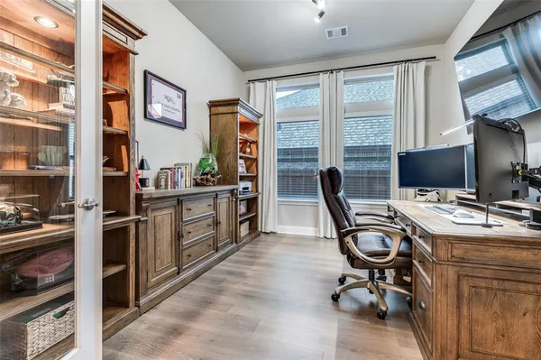 a view of a workspace with furniture and a window