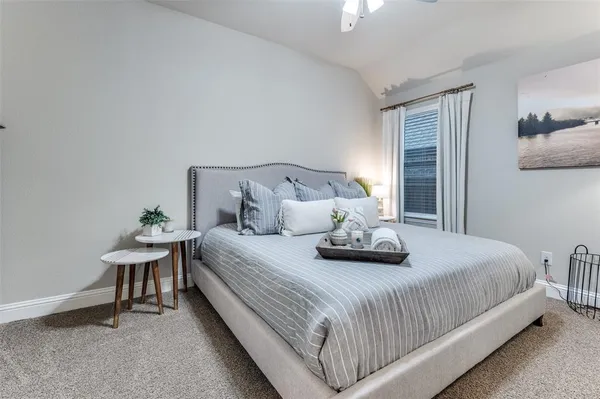 a bedroom with bed and a window