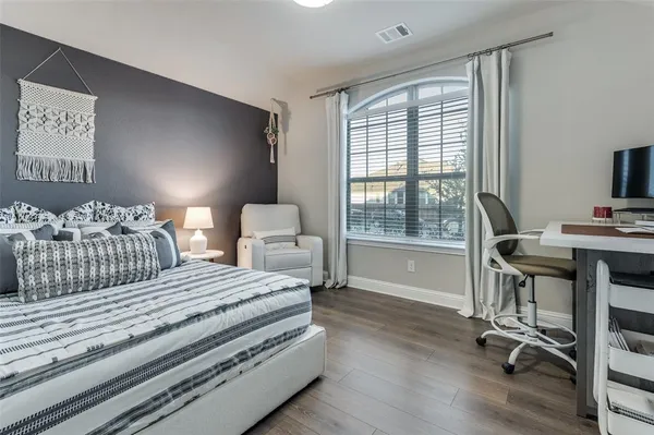 a bedroom with a bed and a desk
