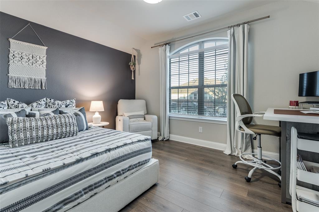 425 Acadia Lane Forney, TX 75126 - Photo 22 of 37 a bedroom with a bed and a desk