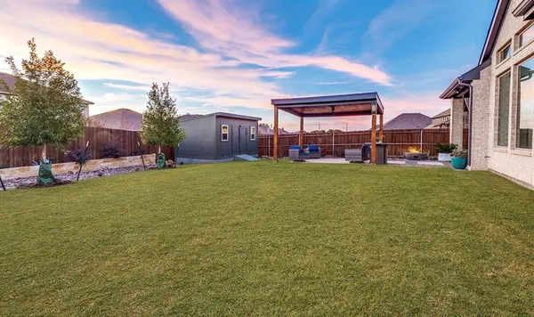 a view of a house with a big yard and potted plants