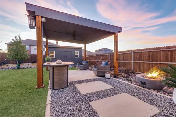 a view of a couches and dinning table in backyard