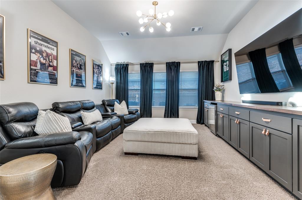 425 Acadia Lane Forney, TX 75126 - Photo 4 of 37 a spacious bedroom with a large bed and a chandelier