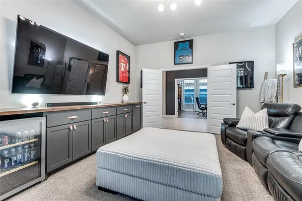 a spacious bedroom with a bed a couch and a flat screen tv