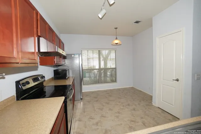 a kitchen that has a sink and a stove in it