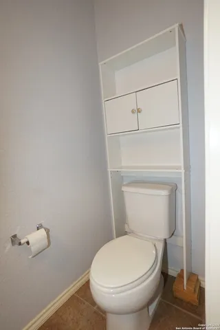 a white toilet sitting next to a shower