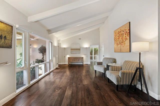 a kitchen with stainless steel appliances granite countertop a stove top oven a sink dishwasher and white cabinets with wooden floor