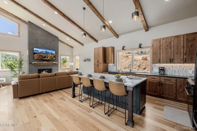 a kitchen with a wooden table and chairs