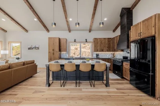 a large kitchen with a table and chairs
