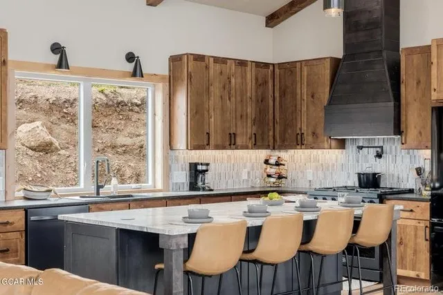a kitchen with a table chairs and a window