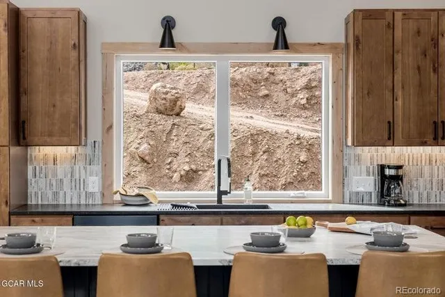 a living room with large window and a wooden floor