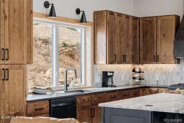 a kitchen with a sink a window and cabinets