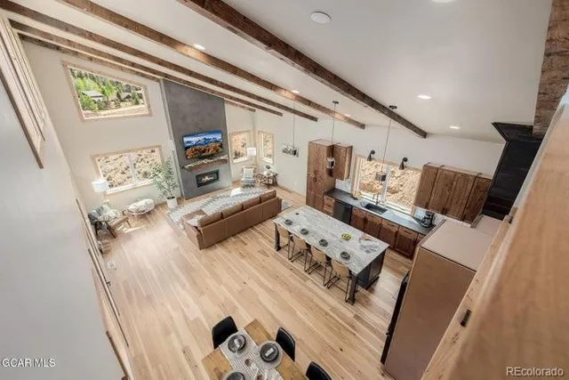 a view of a hallway with wooden floor and potted plant