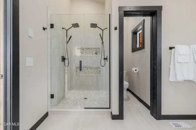 a bathroom with a granite countertop tub a double vanity sink and a mirror