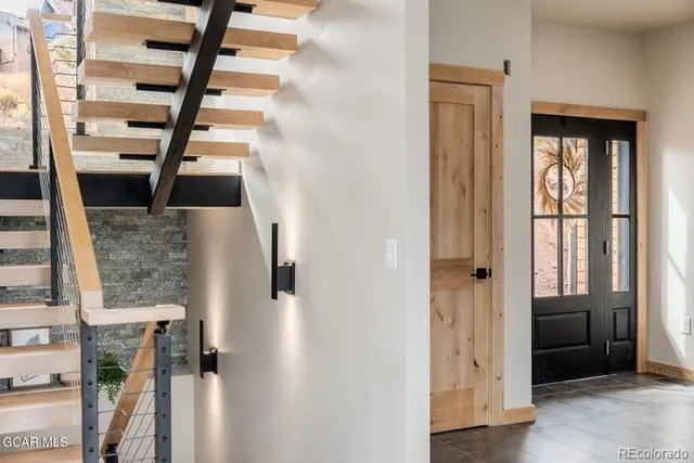 a view of entryway and hall with wooden floor