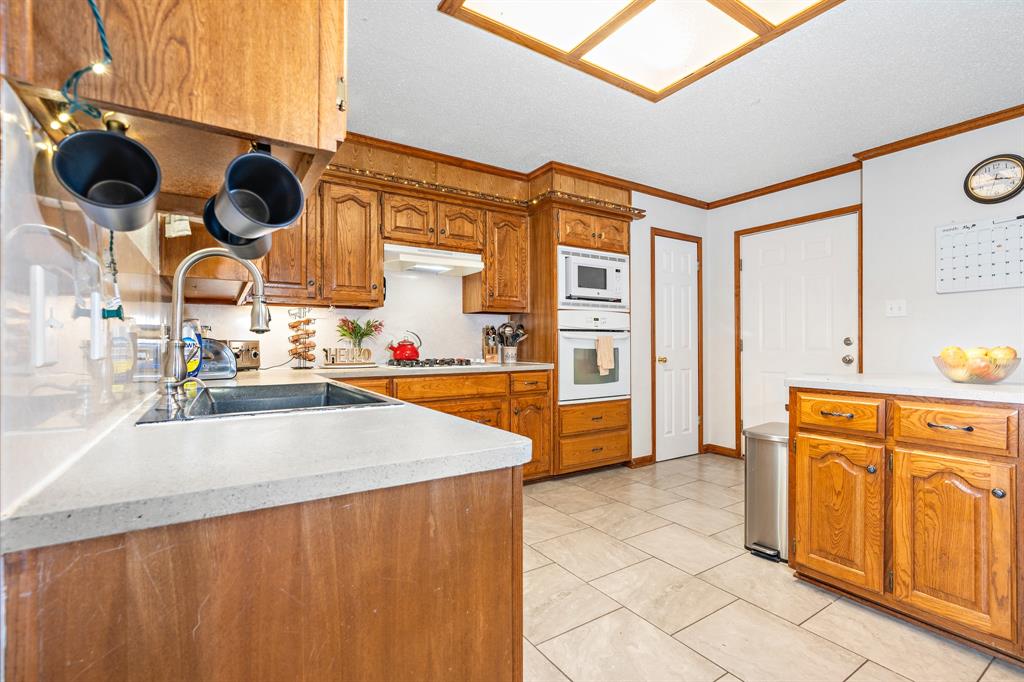 4037 Old Dallas Road Elm Mott, TX 76640 - Photo 12 of 40 a kitchen with stainless steel appliances granite countertop a sink and a cabinets