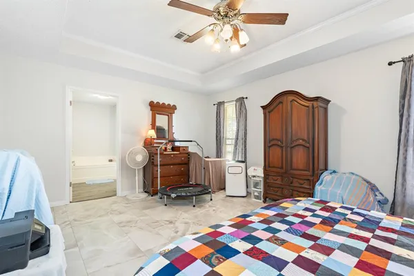 a bedroom with furniture and a chandelier