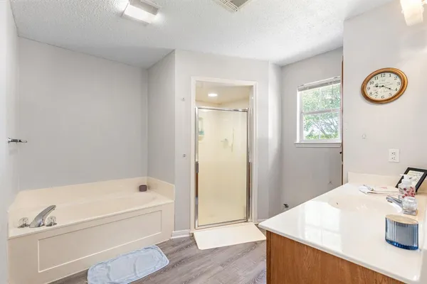 a bathroom with a sink a mirror and a bathtub