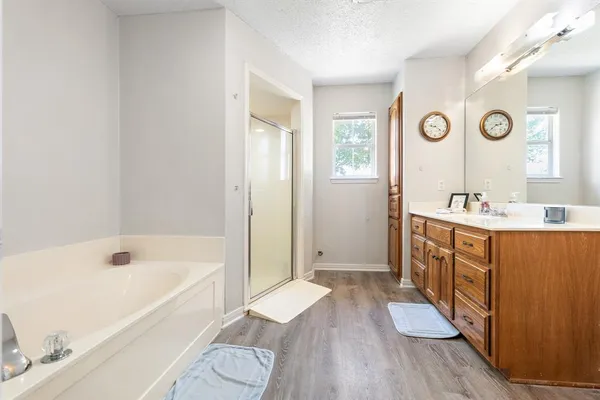 a spacious bathroom with a double vanity sink a mirror and a toilet