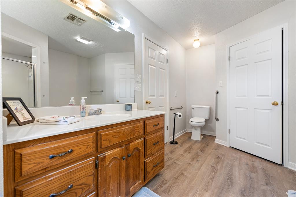 4037 Old Dallas Road Elm Mott, TX 76640 - Photo 18 of 40 a spacious bathroom with a double vanity sink a mirror and a toilet