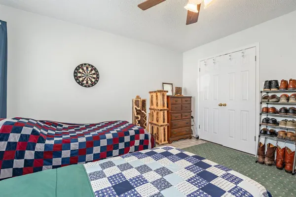 a bedroom with furniture and a large window