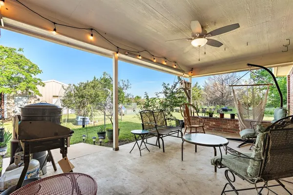 a view of a house with a yard and sitting area