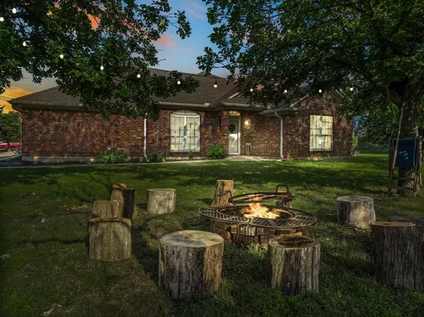 a view of a house with a backyard porch and sitting area