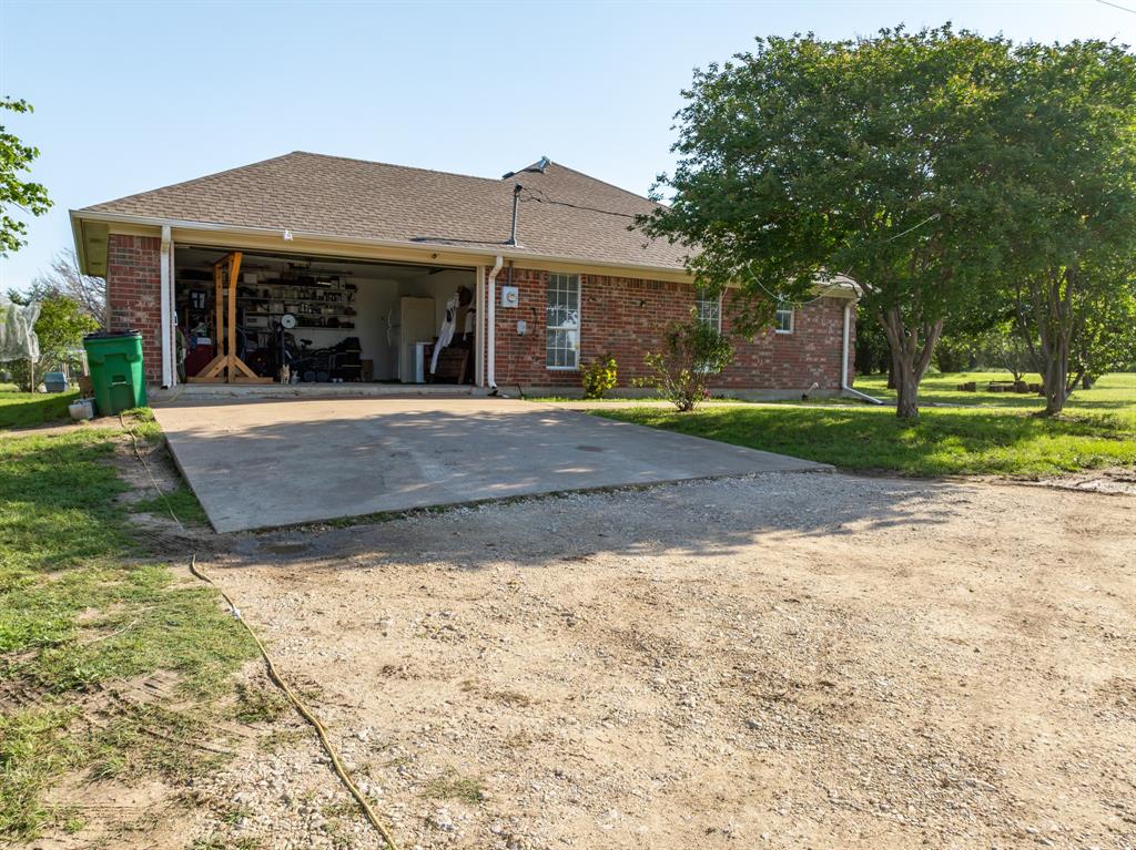 4037 Old Dallas Road Elm Mott, TX 76640 - Photo 29 of 40 a front view of a house with a yard and trees