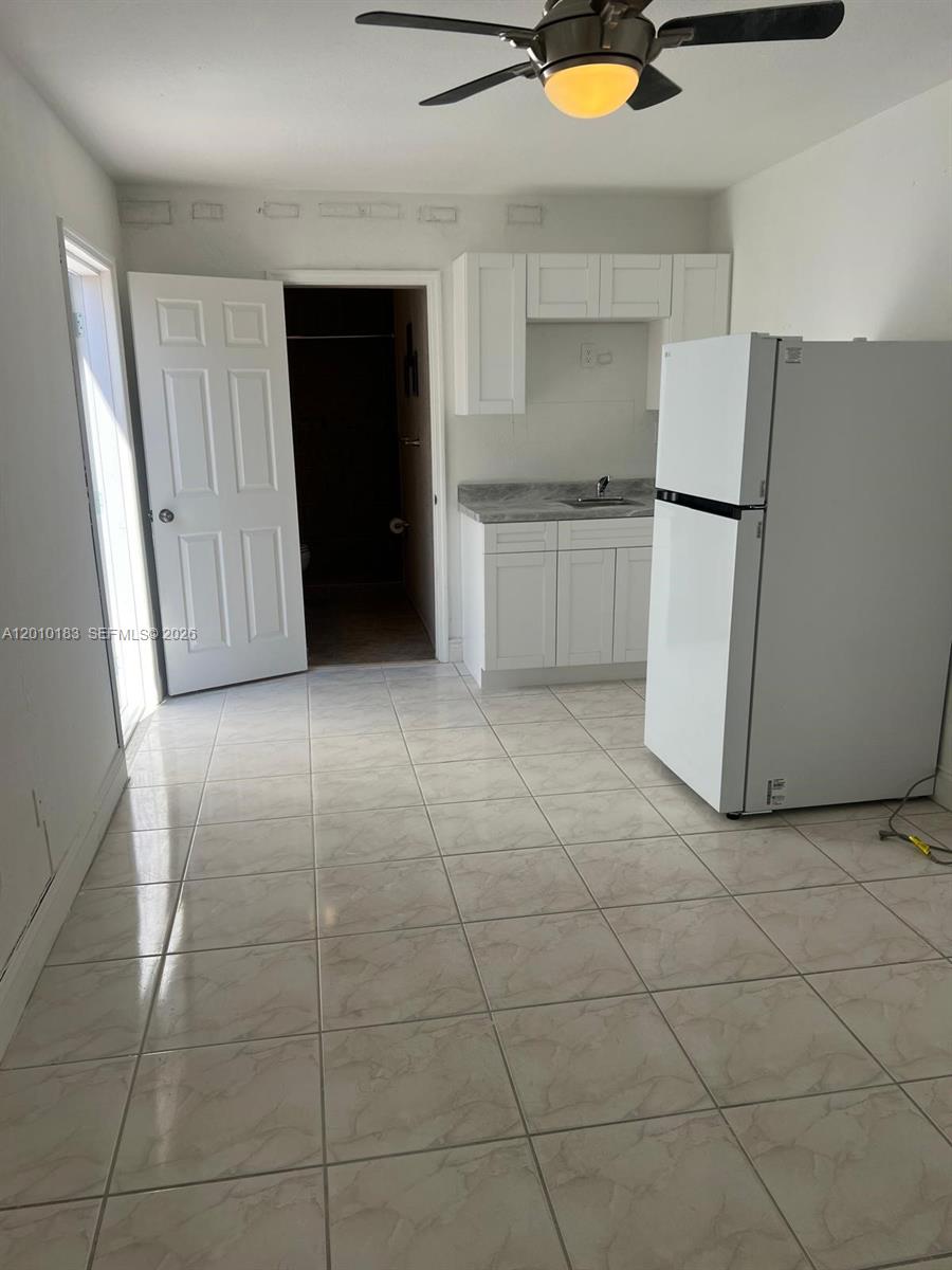 12255 Southwest 29th Terrace Miami, FL 33175 - Photo 1 of 5 a kitchen with a sink a refrigerator and cabinets