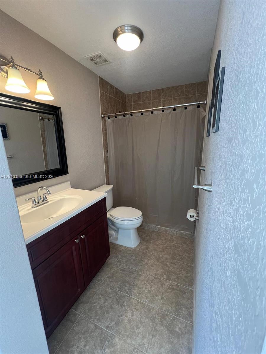 12255 Southwest 29th Terrace Miami, FL 33175 - Photo 3 of 5 a bathroom with a sink vanity mirror and toilet
