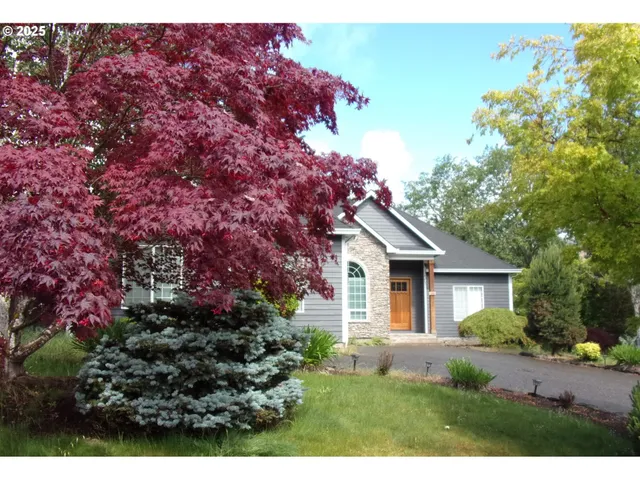 a front view of a house with a garden