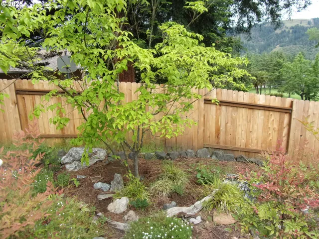 a backyard of a house with lots of green space and a fountain