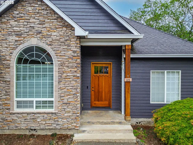 an aerial view of a house with a garden and trees