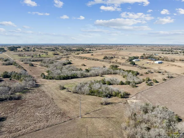 a view of a big yard with lots of green space