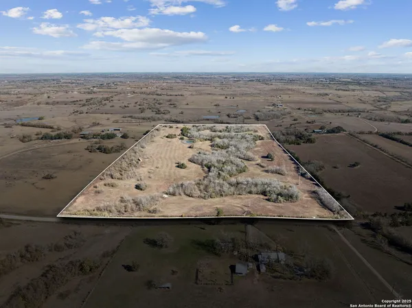 an aerial view of beach and building