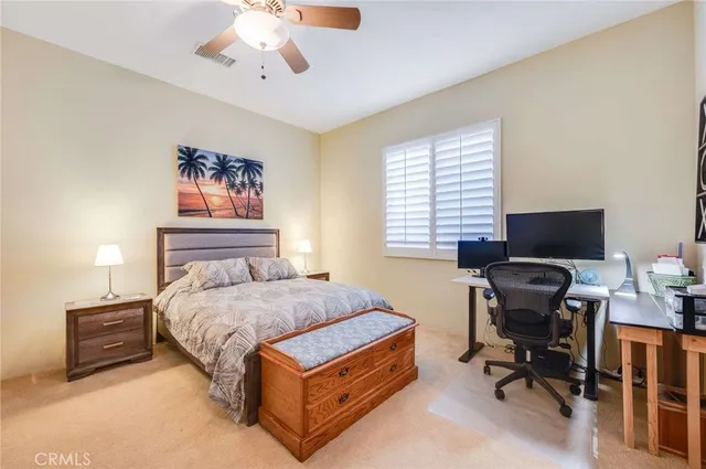 a bedroom with a bed and a desk