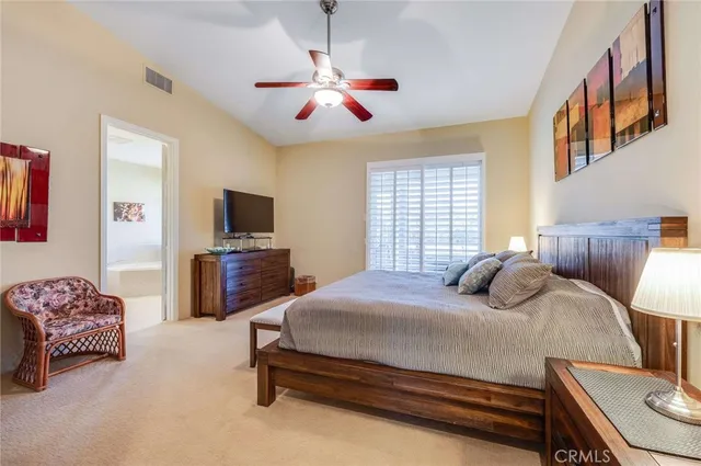 a bedroom with a bed furniture and a flat screen tv