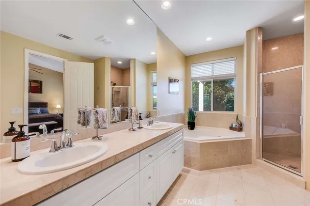 a bathroom with double vanity sinks double vanity and a bathtub
